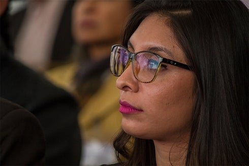 A woman wearing glasses and pink lipstick