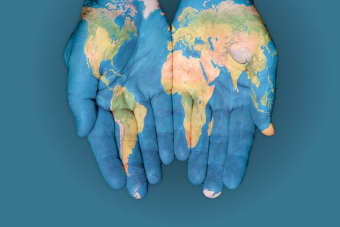 Hands painted with world map - Inter-American Development Bank - IDB