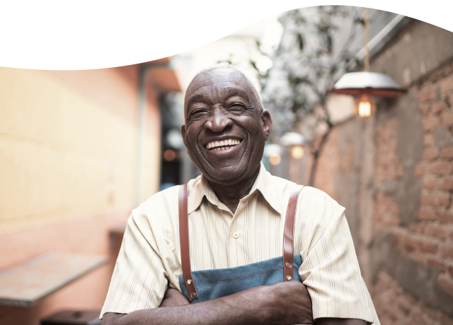 Men with and apron smiling - About IDB - Inter American Development Bank - IDB