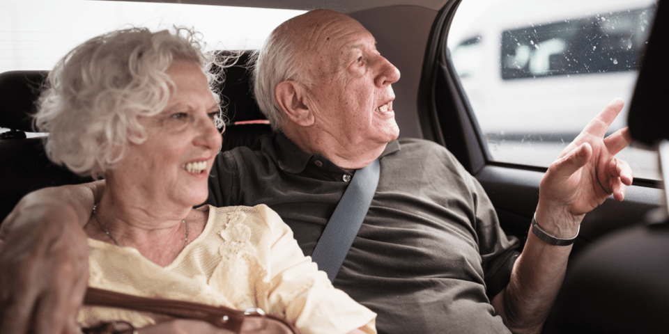 Seniors smiling aboard a vehicle - Inter American Development Bank - Healthcare