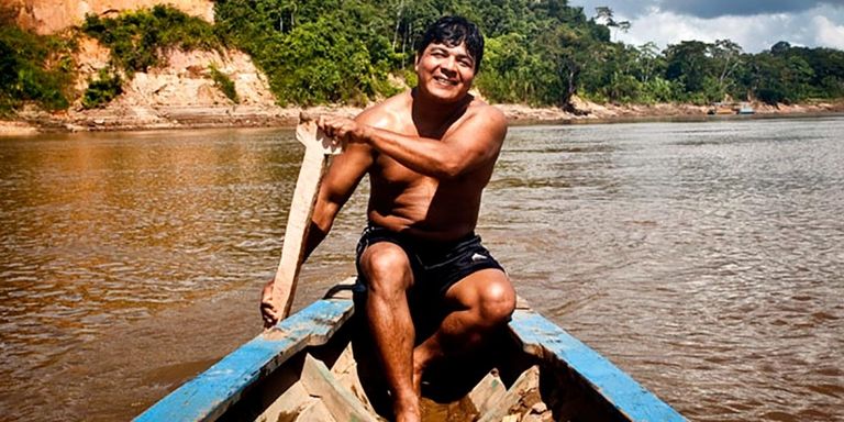 A man sitting in a boat. Economic Development - Inter-American Development Bank - IDB