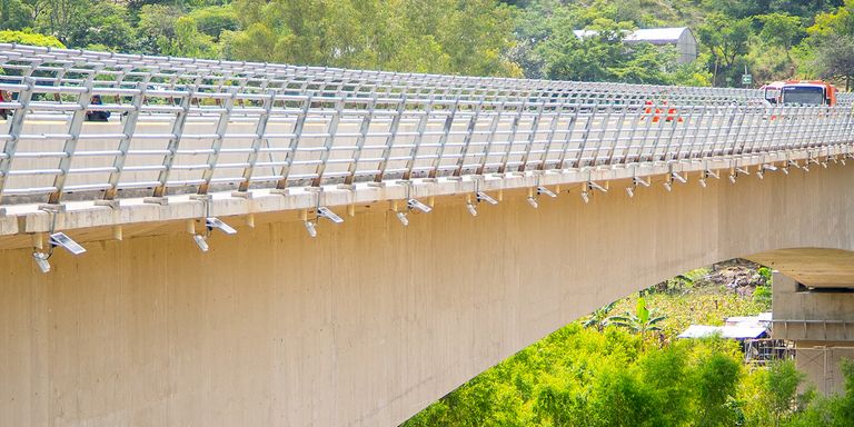 Close-up of a bridge over a river in Latin America, representing development projects