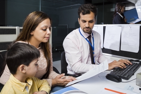 Women and men with a boy in office - Inter American Development Bank - IDB Financial Markets