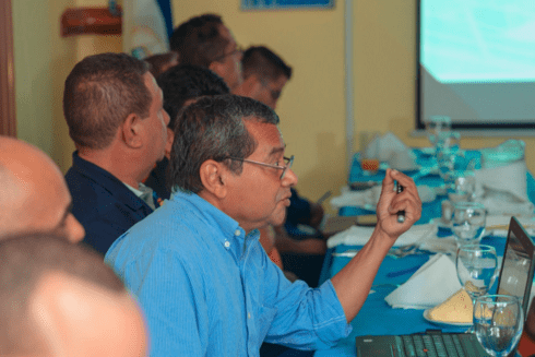 An older man at a conference table