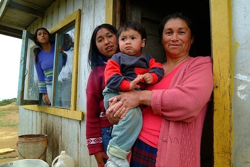 Group of people standing in their house door. Labor market - Inter-American Development Bank - IDB