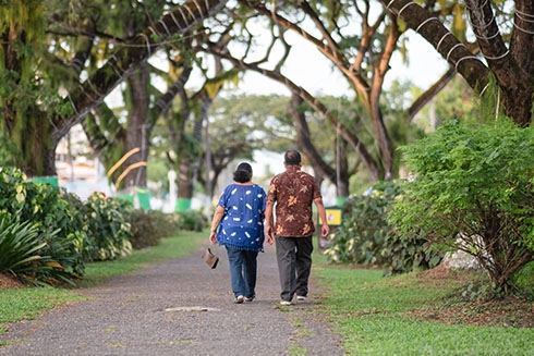 A couple walking on a path holding hands