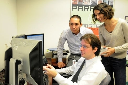 a group of people looking at a computer screen