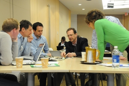 a group of people working on laptops