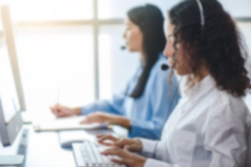 a group of women working at a computer