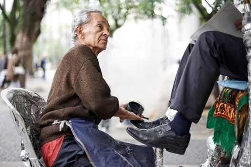 "a person sitting on a bicycle with his feet on the ground  Sustainable - Inter-American Development Bank - IDB"