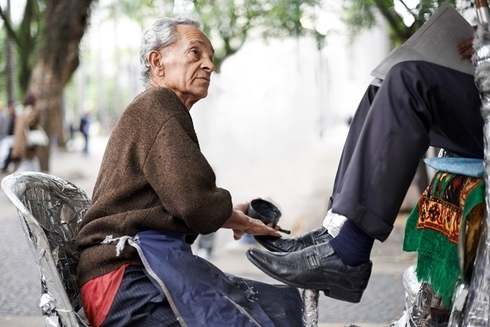 "a person sitting on a bicycle with his feet on the ground Sustainable - Inter-American Development Bank - IDB"