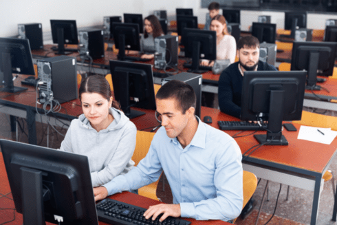 a group of people working on computers Development - Inter-American Development Bank - IDB