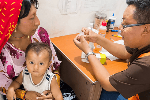 a person holding a baby Equity - Inter-American Development Bank - IDB