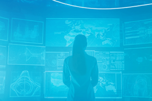 Woman standing with her back to screens - Inter American Development Bank - BIDAcademy