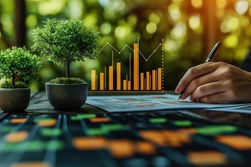 Executive writing on a paper with nature background - Inter American Development Bank - Investors
