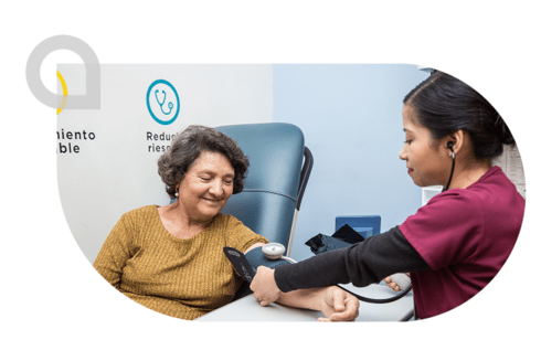 Elderly woman having her blood pressure taken by a nurse - Inter American Development Bank - Institutional Strategy