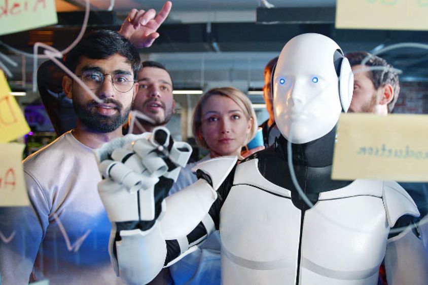 Group of people looking at a robot. Innovation and Work - Inter-American Development Bank - IDB