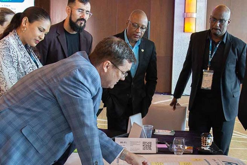 a group of people looking at a table