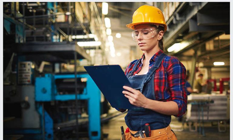 A woman using safety equipment holding a clipboard. Gender equality - Inter-American Development Bank - IDB