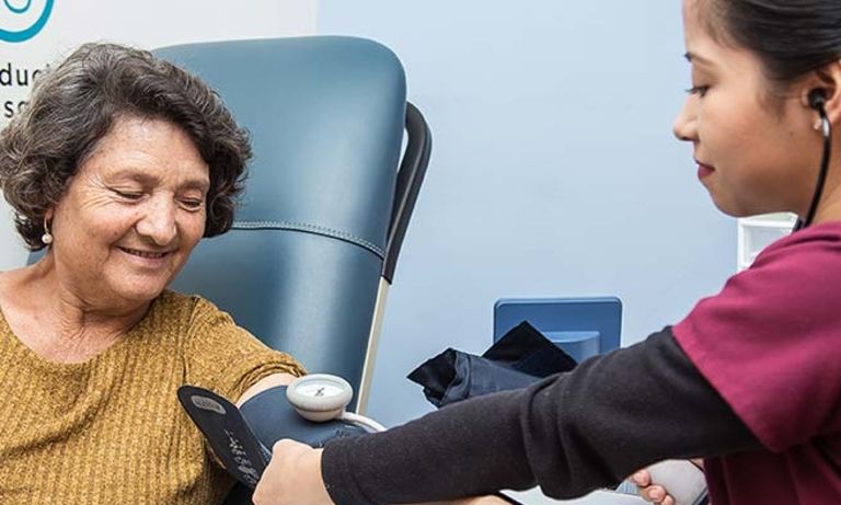 a person taking a blood pressure of a person